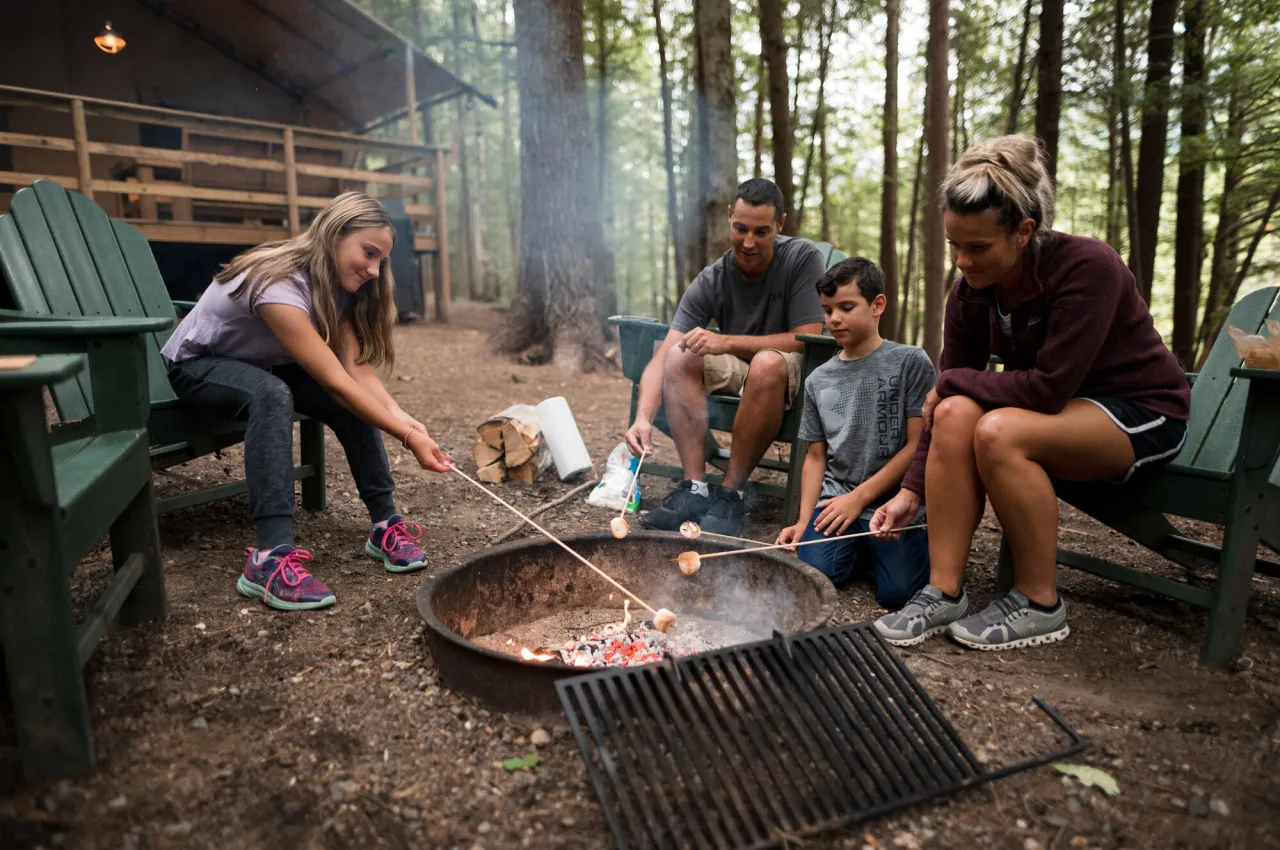 A family roasts marshmallows around the campfire