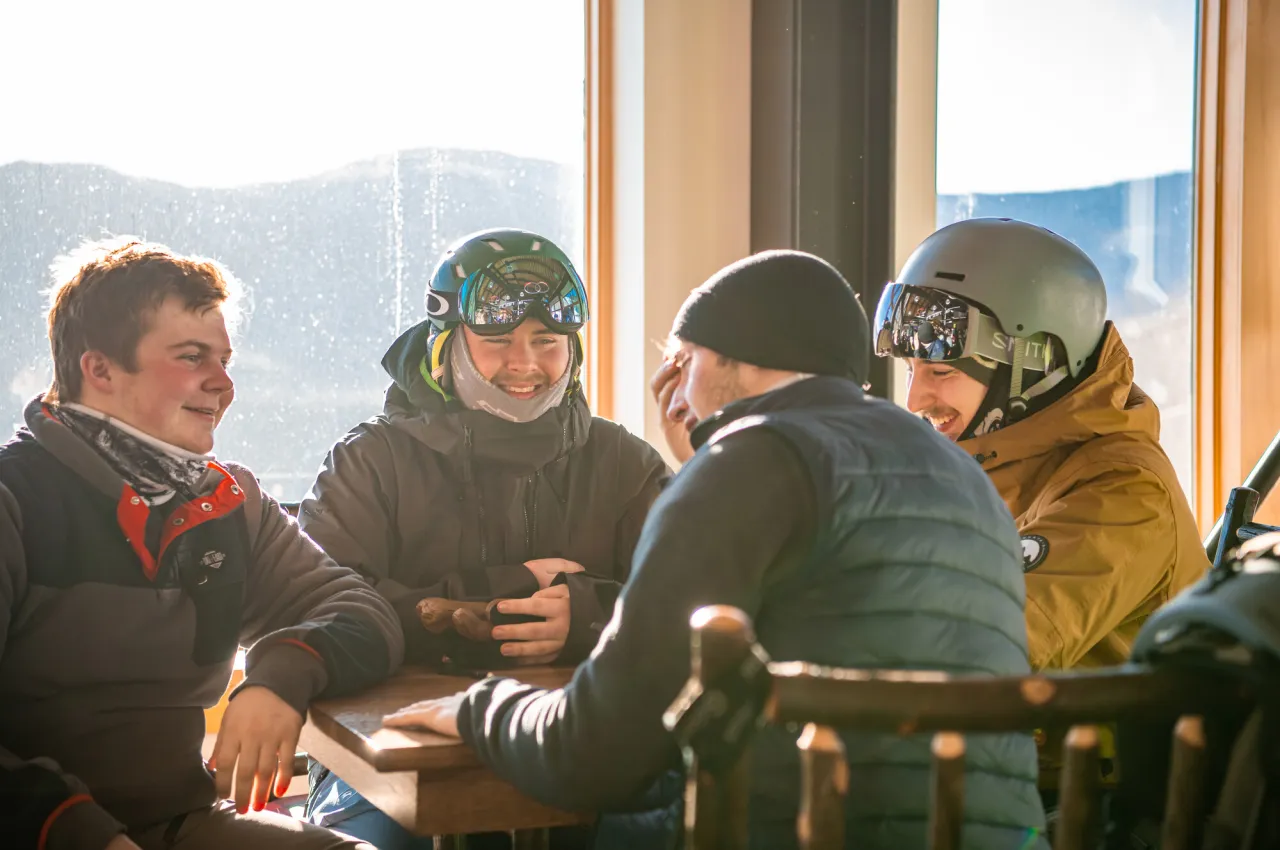 Four guys resting at a ski lodge