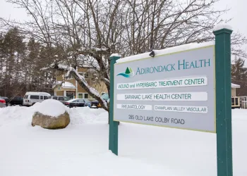 Entry sign with doctor names at the front of the Saranac Lake Health Center