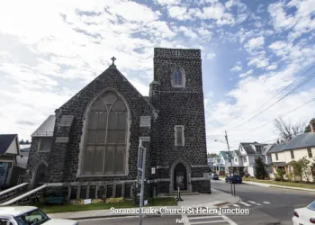 Exterior of the tall grey stone church