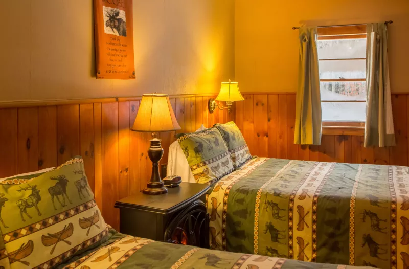 Two comfortable beds, freshly made at the ADK Trail Inn.
