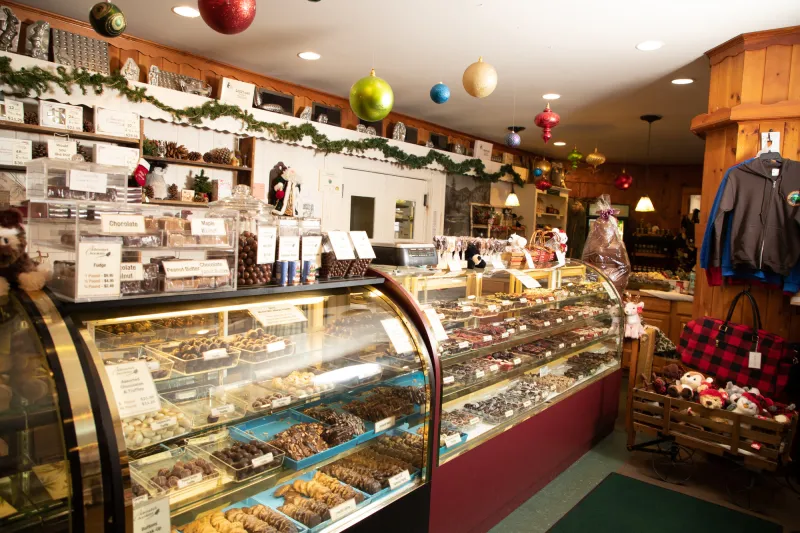 The interior of a chocolate store with lots of chocolate treats on display.