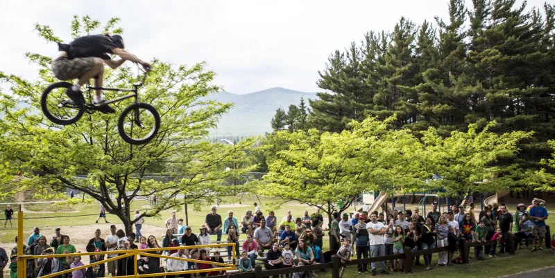 A rider goes over a jump as the crowd watches