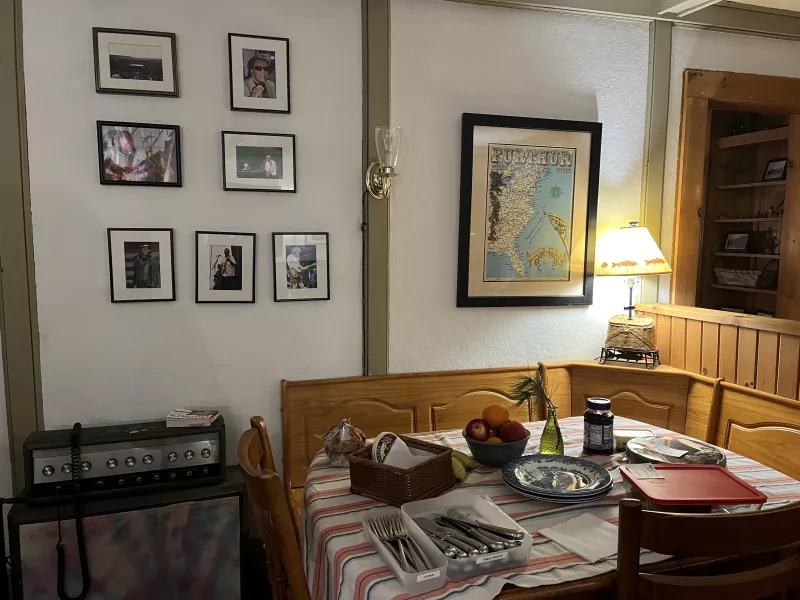 A cozy breakfast nook set with plates, utensils, and fresh fruit