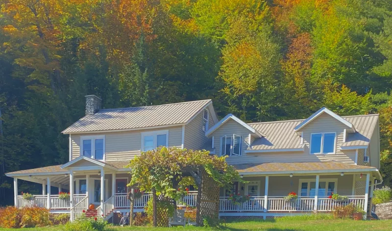 The tan and white-trimmed front of Whiteface Farm B&B