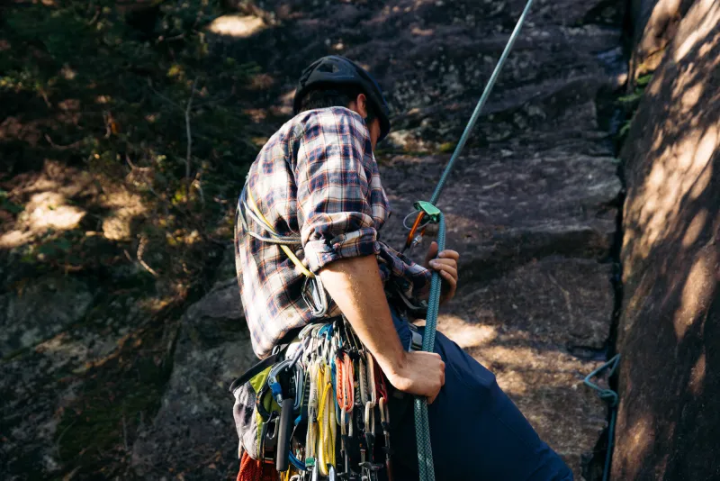 A climber rappelling off a route