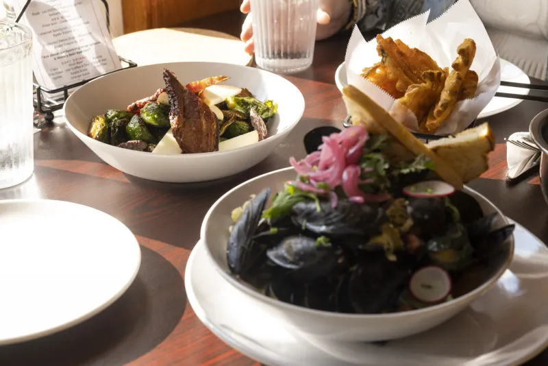 A selection of mussels and other dishes on a table.