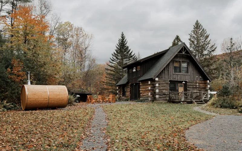 A trail leads to a small log cabin.