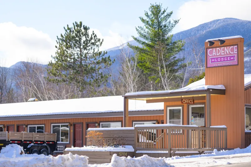 The front entrance of the Cadence Lodge, a 1950's style motor lodge in the Whiteface Region on a snowy day