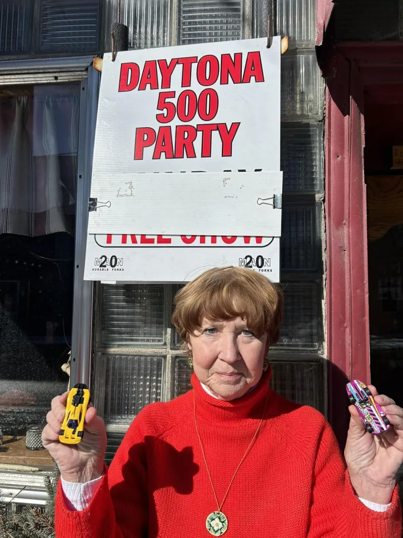 woman holding toy stock cars