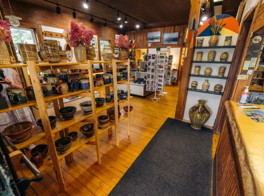 Interior view of Jay Craft Center with pottery on various shelves