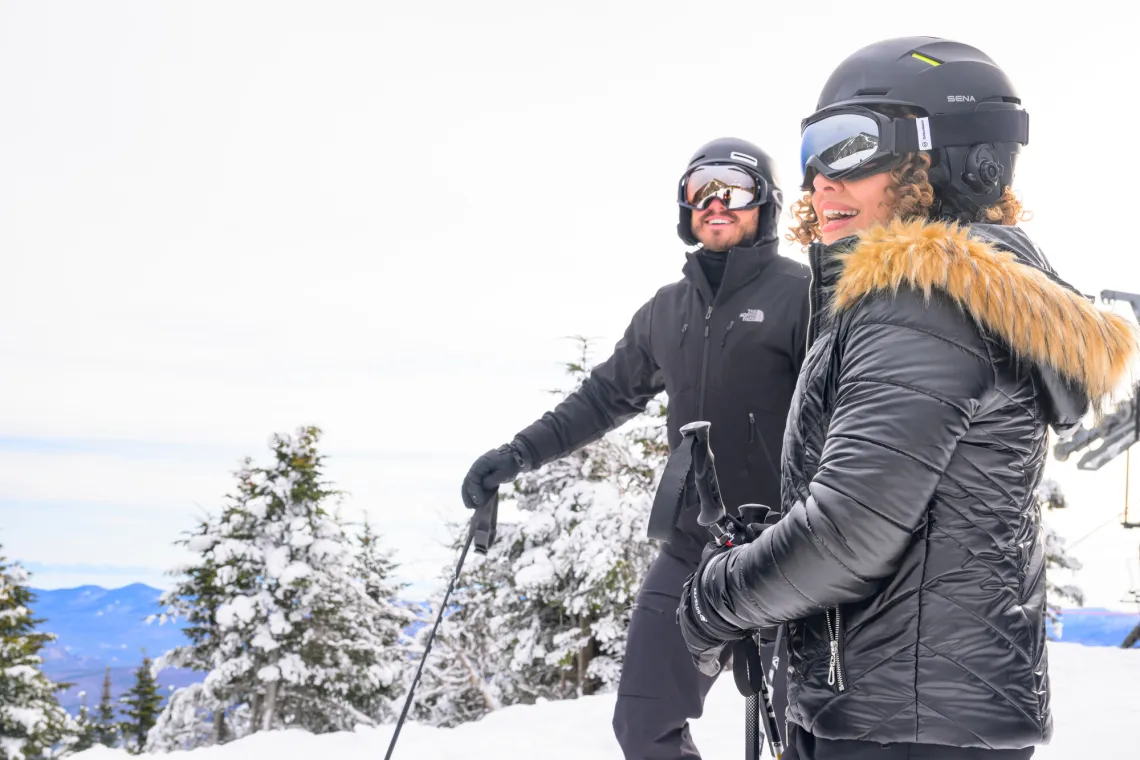 Two skiers smiling on the slope