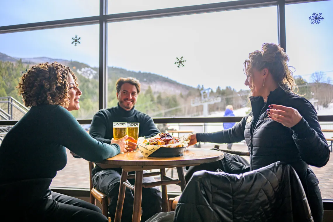 A group drinking and eating at a ski resort dining area