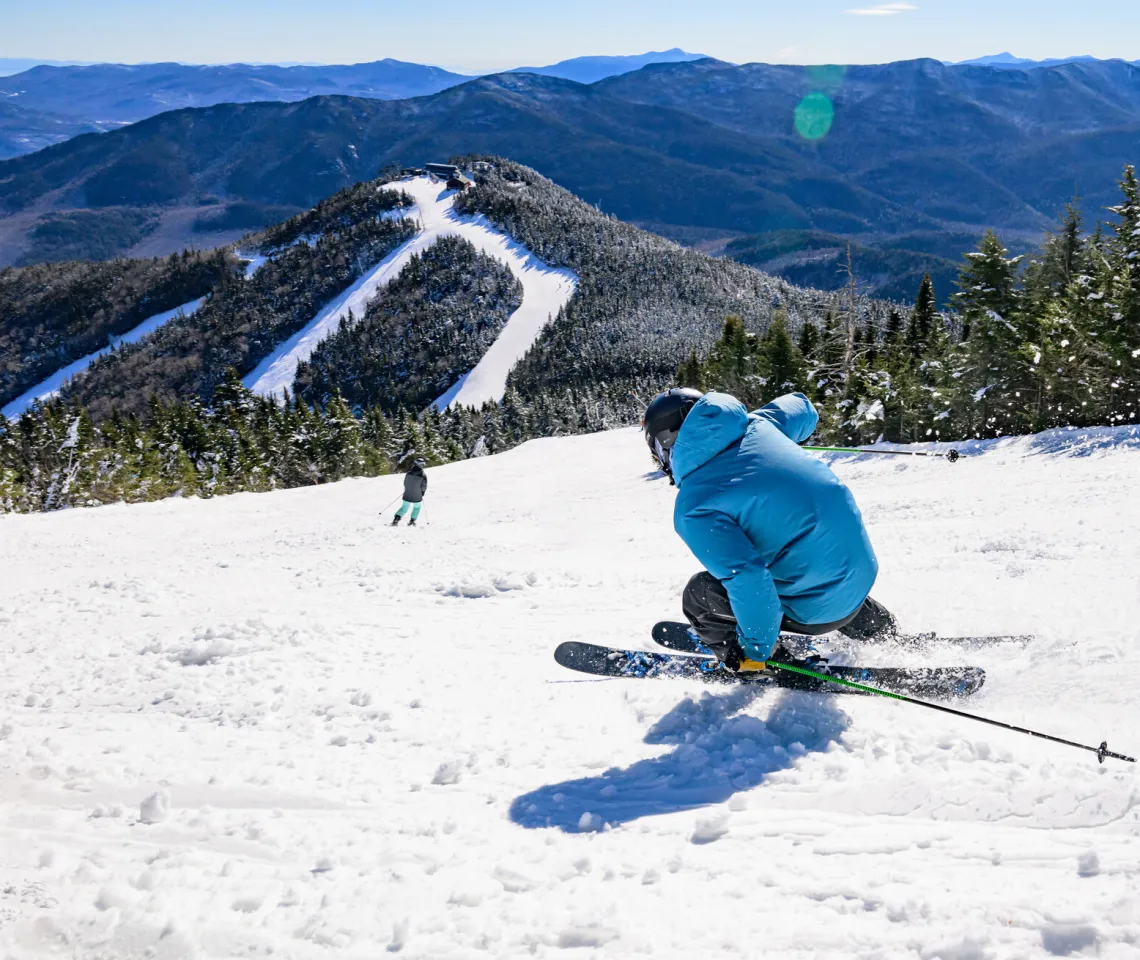 A skier turns sharply down the mountain