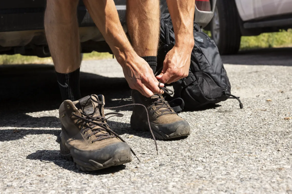 Lacing up hiking boots.