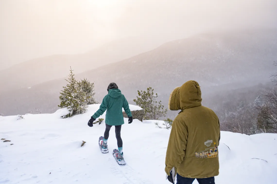 Hikers snowshoeing toward summit view